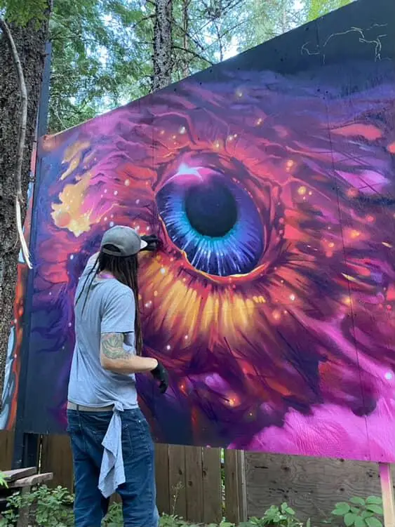 Aaron Brown painting a mural